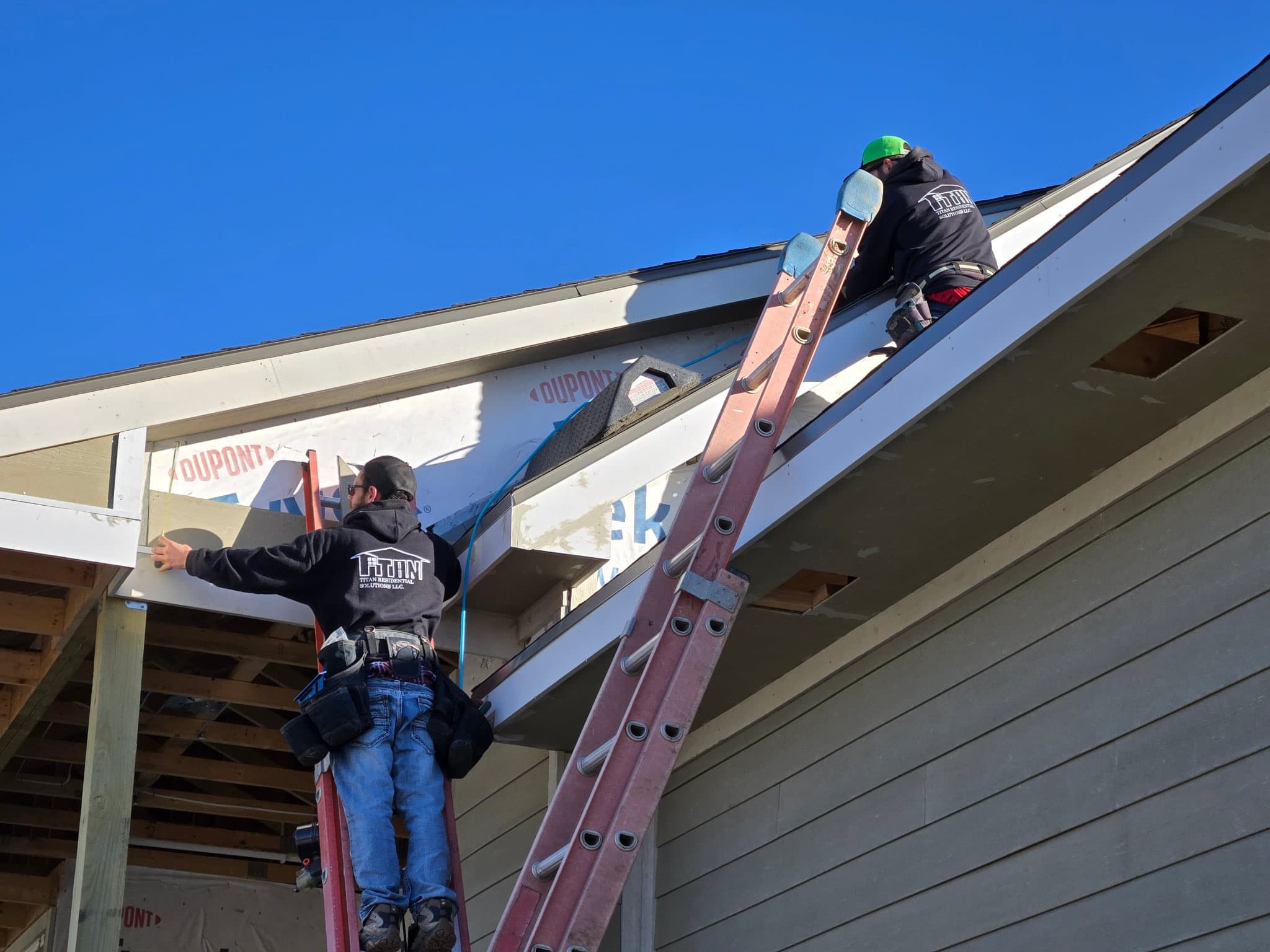 Titan Residential Solutions crew installing exterior trim on a residential home